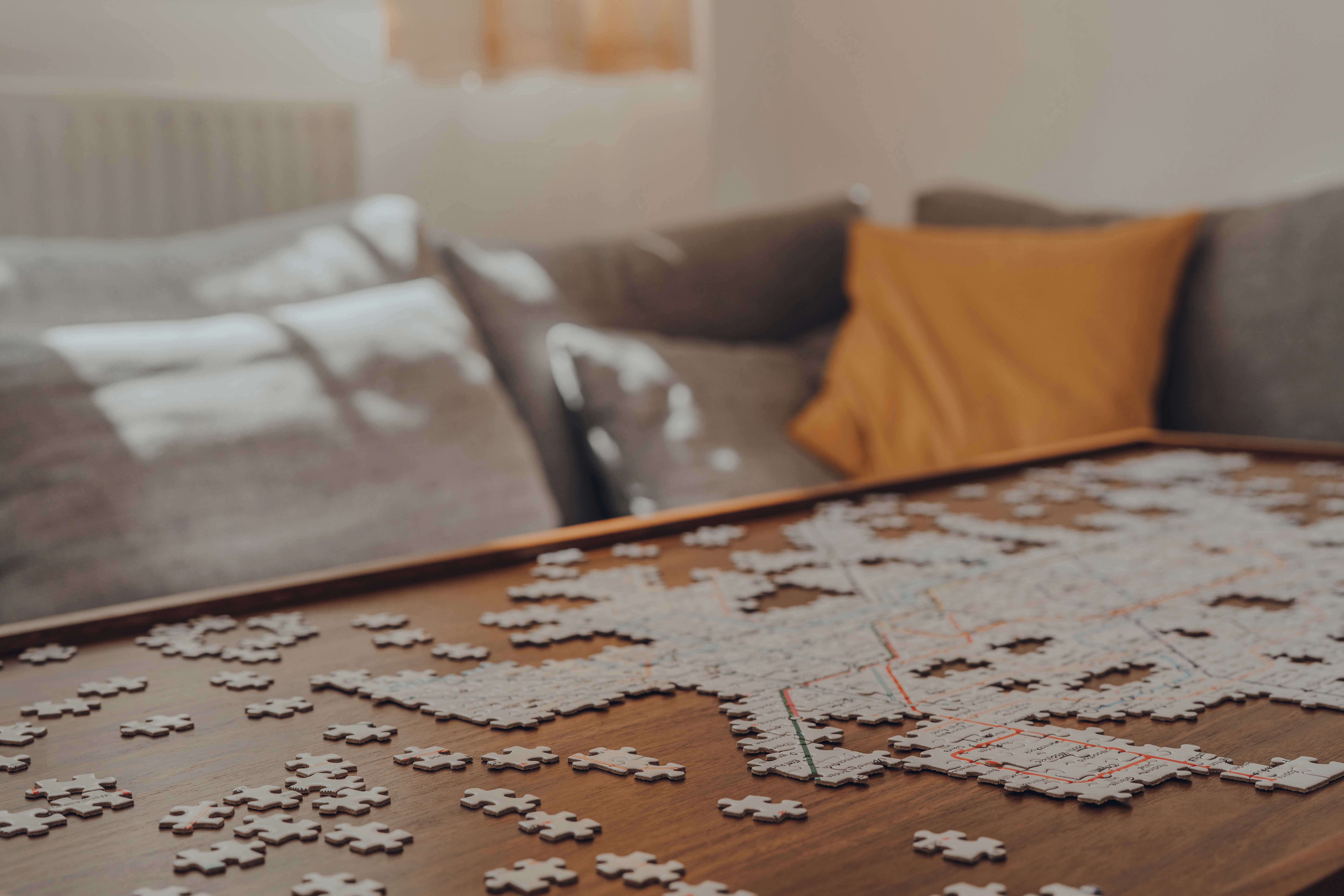 Jigsaw puzzle halfway pieced together on a living room coffee table